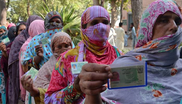 women voters que outside poling station