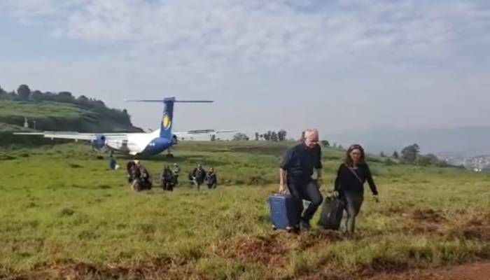 plane lands in field in rawanda